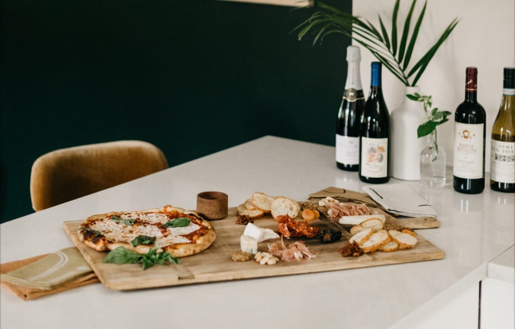 A selection of wine, cheeses and pizza from Taverna San Marco.